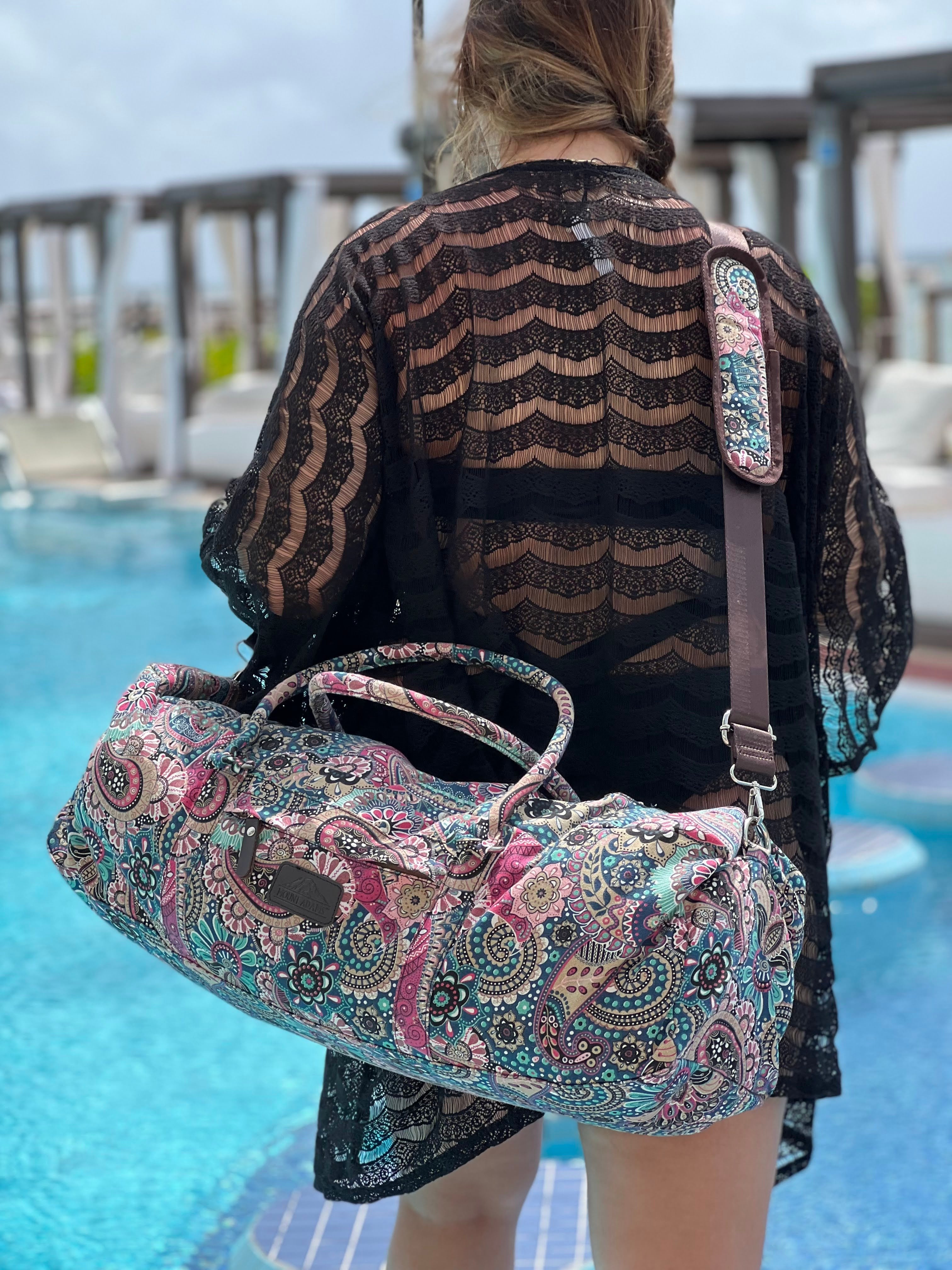 girl holding majestic yoga duffle bag at pool